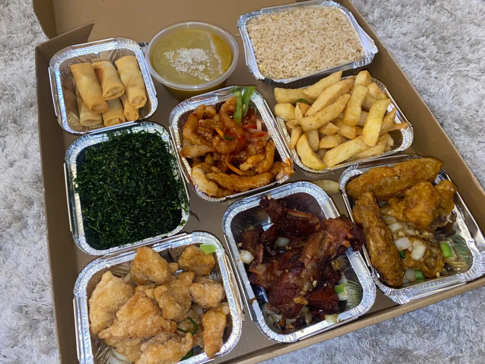 A banquet box loaded with spring rolls, salt & chilli chicken, chips, ribs and wings