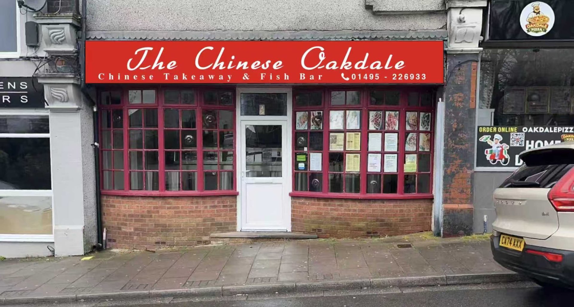 The Chinese Oakdale shopfront by day — red signage above red-framed bay windows